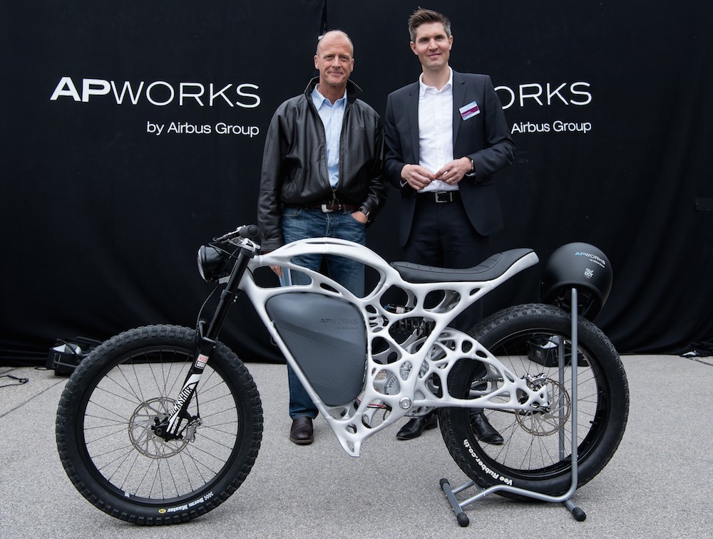 Enders (left) and Zettler presenting a Light Rider motorcycle printed in 3D technique by APWorks. - AFP