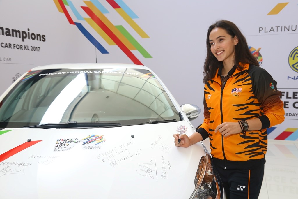 National gymnast Farah Ann Abdul Hadi with the Peugeot 208 pledge car.