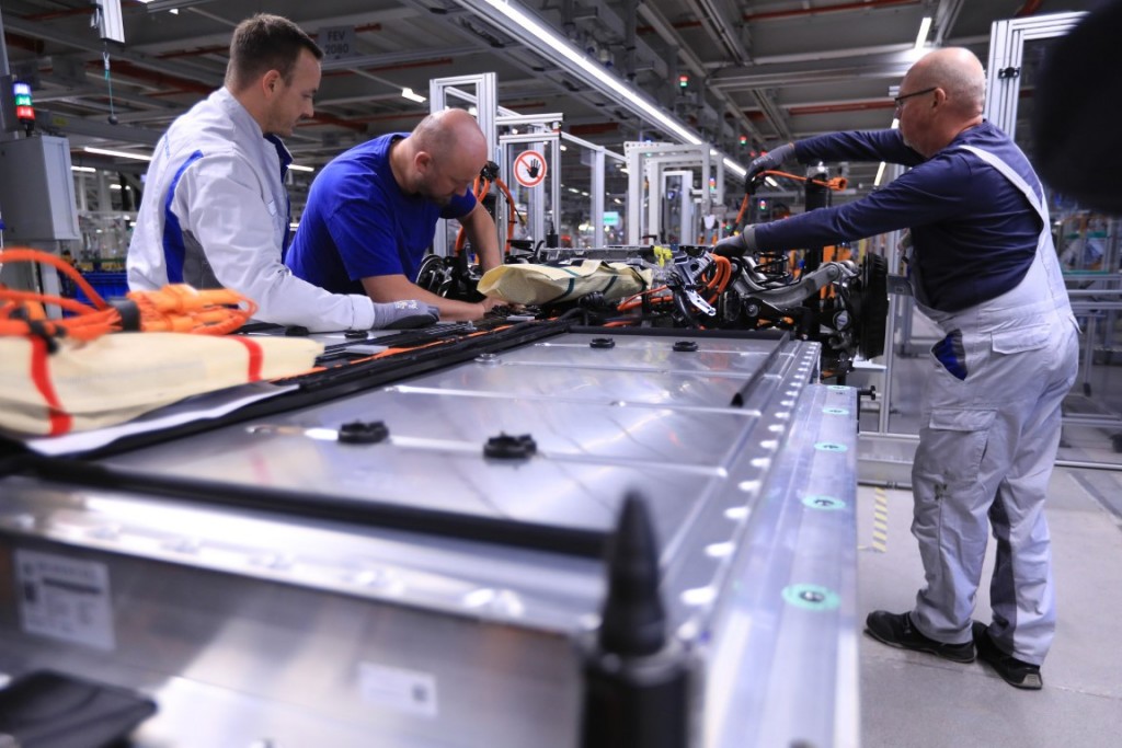 Employees connect a lithium-ion automotive battery pack to an electric motor on the Volkswagen AG (VW) ID.3 electric automobile assembly line at the automaker's factory in Zwickau, Germany, on Monday, Nov. 4, 2019. Angela Merkels visit to a revamped VW electric-car plant in Zwickau on Monday is a stark reminder of what's at stake both for the German chancellor and VW boss Herbert Diess. Photographer: Krisztian Bocsi/Bloomberg