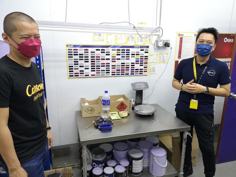 Cheah (left) and Chew at the paint colour-matching section.