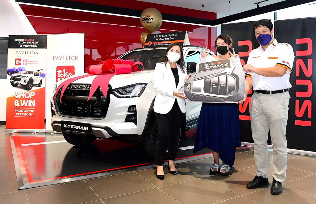 Sogo (right) and Kung presenting the pick-up truck to Zhang.