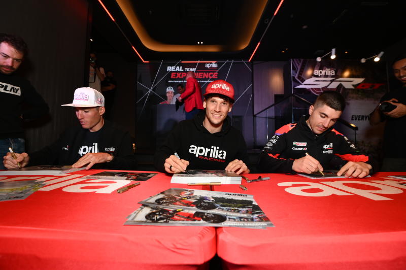 Aprilia Racing Team riders (from left) Aleix Espagaro, Lorenzo Savadori and Maverick Vinales signing autographs at a meet and greet session in Kuala Lumpur.
